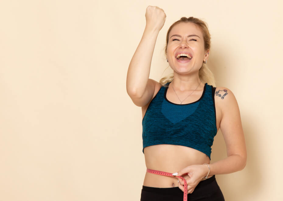 Front view young female sport outfit measuring her sizes waist